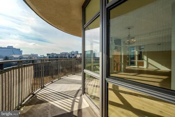 a view of a livingroom with an empty space and kitchen