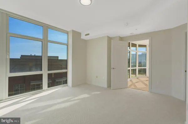 a spacious bathroom with a toilet a sink and mirror