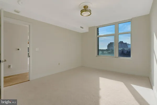 a bathroom with a granite countertop shower a toilet and a sink
