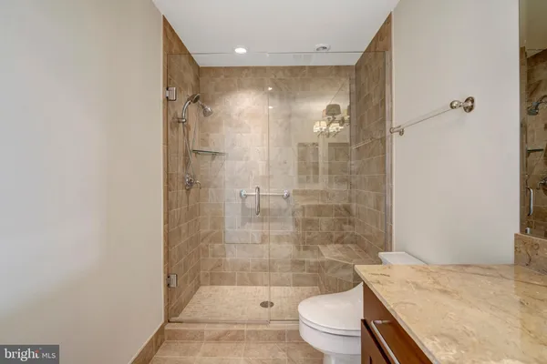 a bathroom with a sink toilet and a mirror