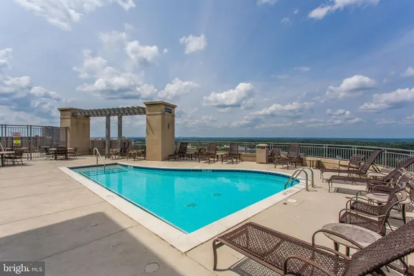 a view of a swimming pool and trees in the background