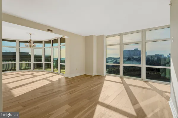 a view of a kitchen with wooden floor and a refrigerator