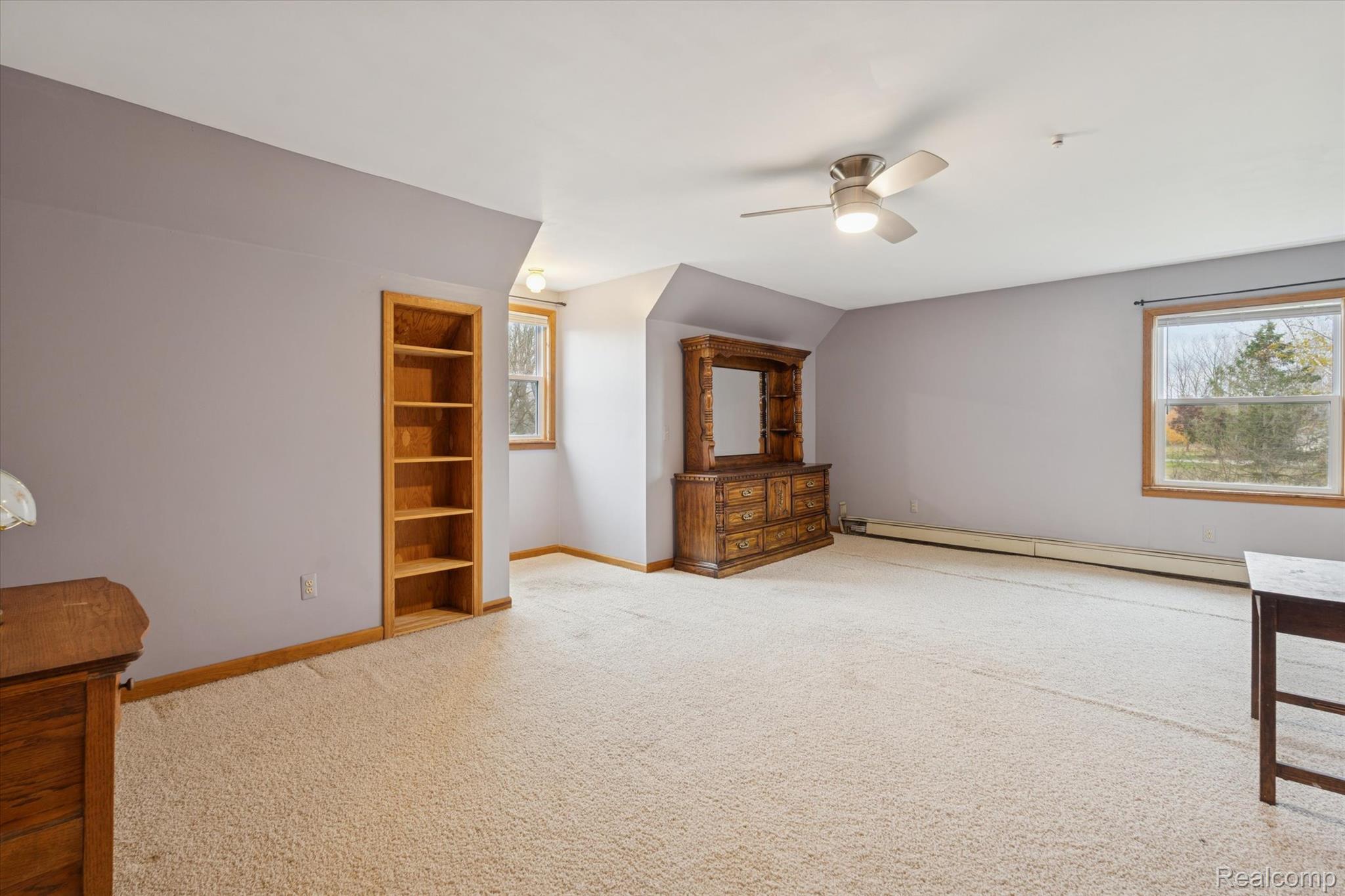 3031 Cedar Point Howell, MI 48843 - Photo 24 of 51 Additional living space featuring a baseboard radiator, light colored carpet, vaulted ceiling, and a ceiling fan