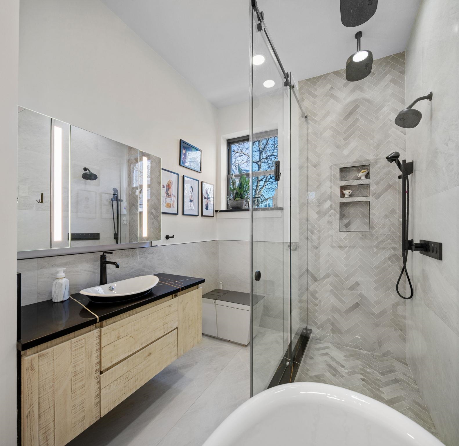 277 York Street, Unit 501 Jersey City, NJ 07302 - Photo 11 of 18 a bathroom with a granite countertop sink a toilet and a mirror