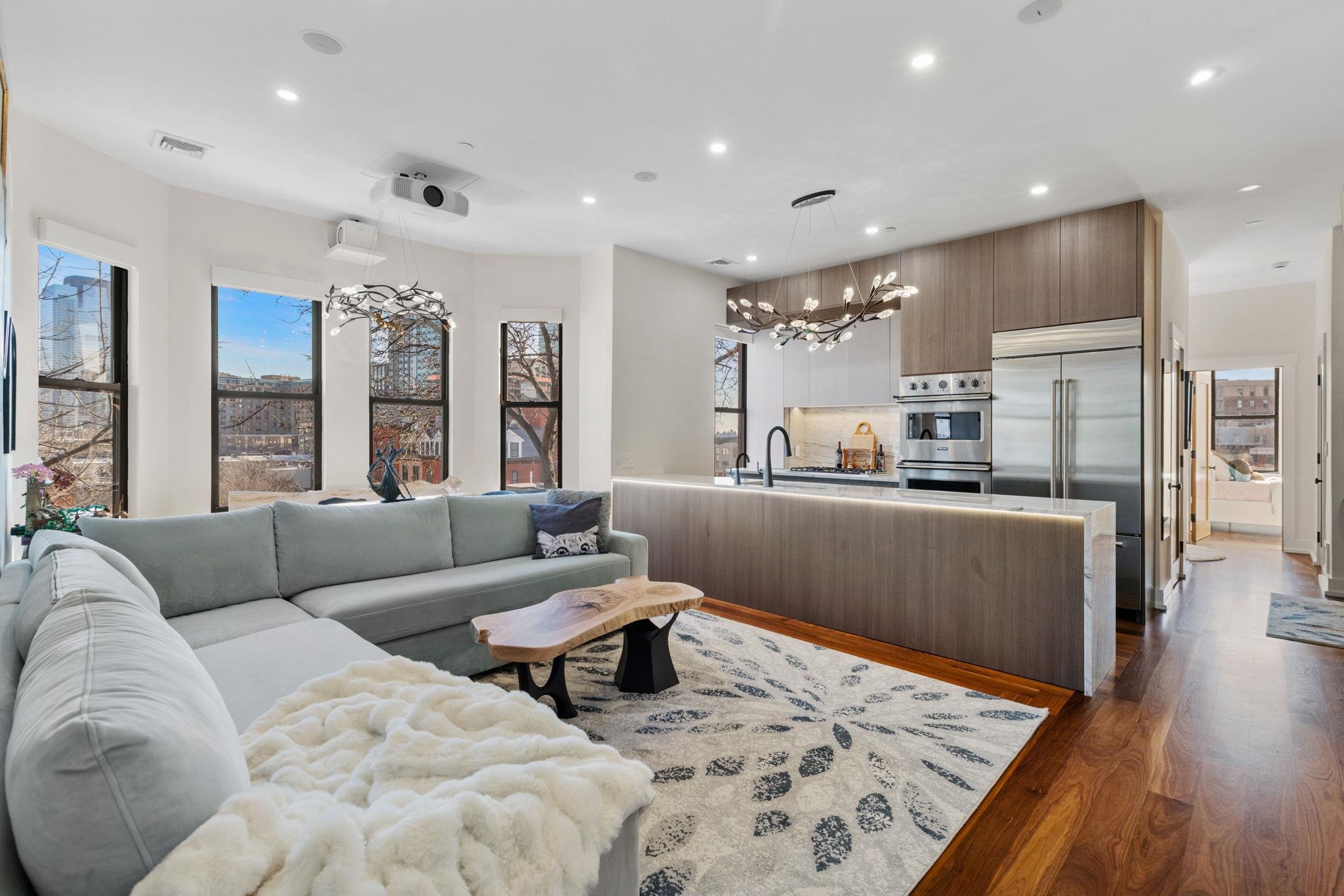 277 York Street, Unit 501 Jersey City, NJ 07302 - Photo 3 of 18 a living room with furniture and kitchen view