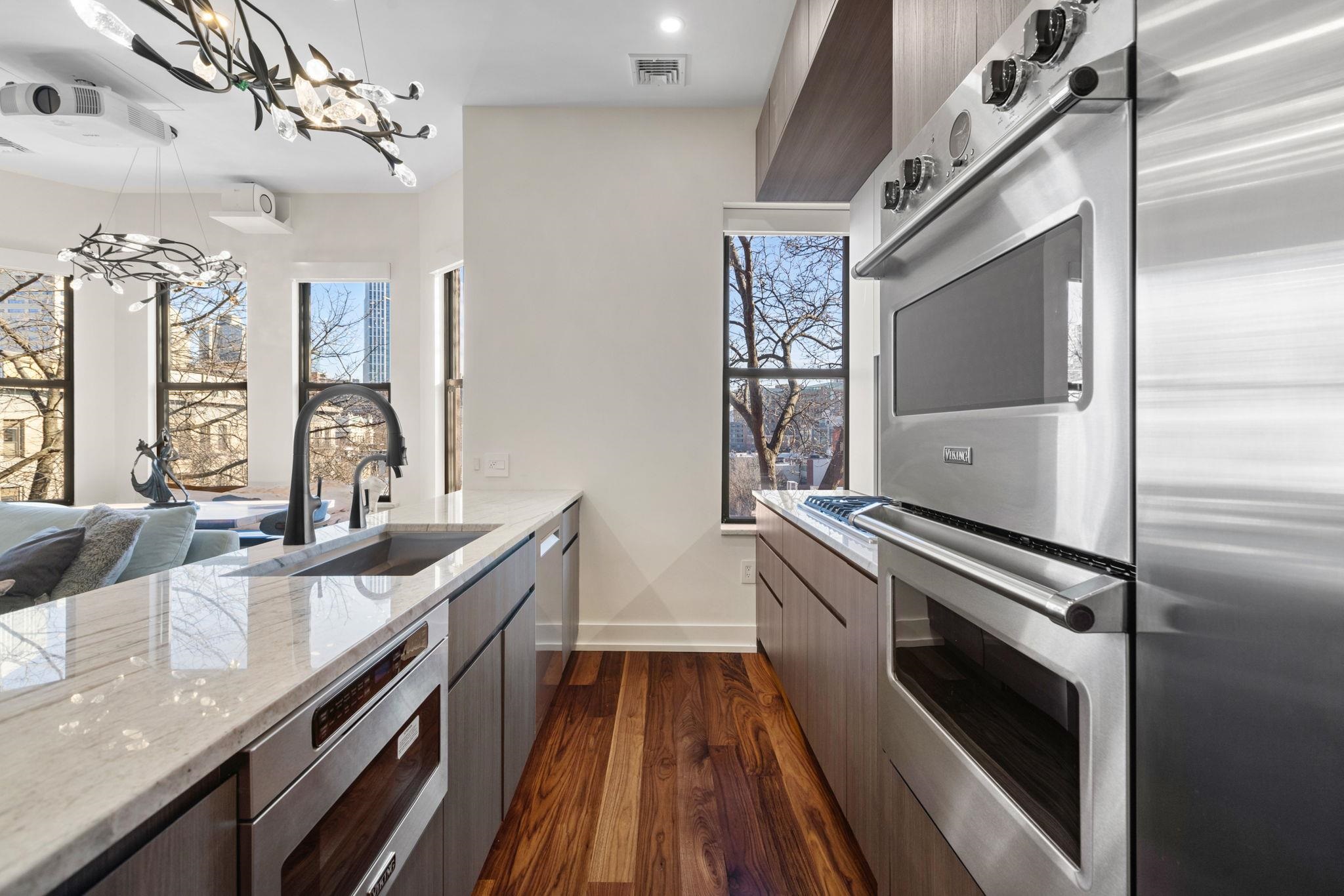 277 York Street, Unit 501 Jersey City, NJ 07302 - Photo 7 of 18 a kitchen with granite countertop a sink appliances and cabinets