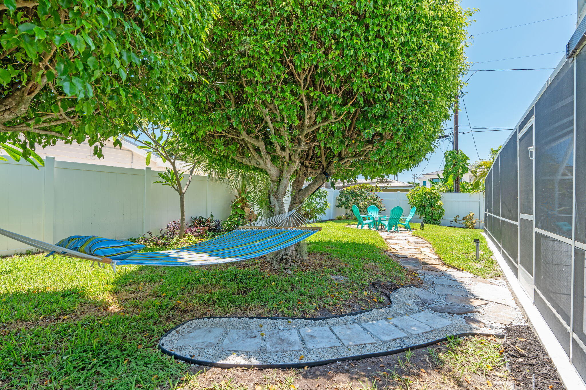 1081 Bimini Lane Singer Island, FL 33404 - Photo 29 of 39 Stone path with hammock