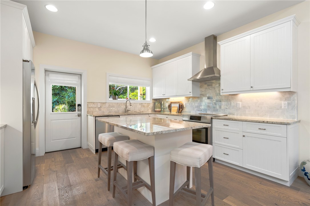 548 Conn Way Vero Beach, FL 32963 - Photo 19 of 34 a kitchen with cabinets a sink stainless steel appliances and window