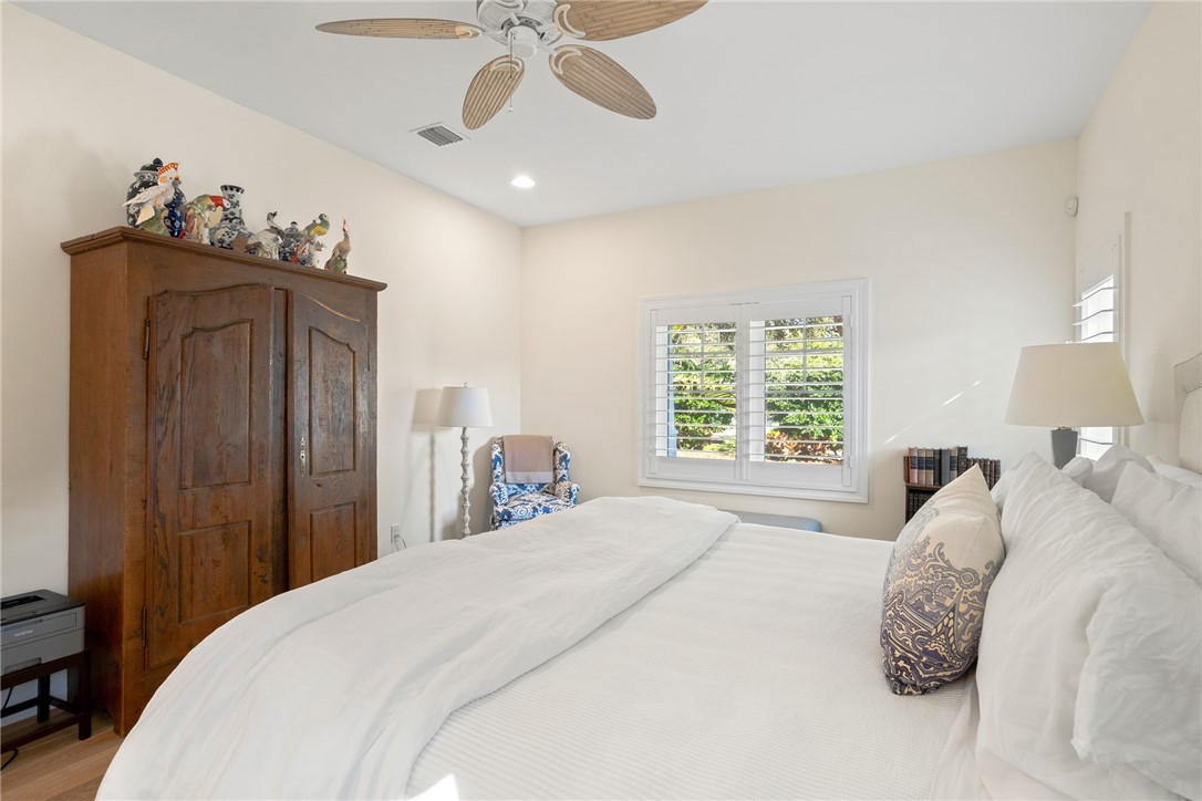 548 Conn Way Vero Beach, FL 32963 - Photo 23 of 34 a bedroom with a bed and a chandelier