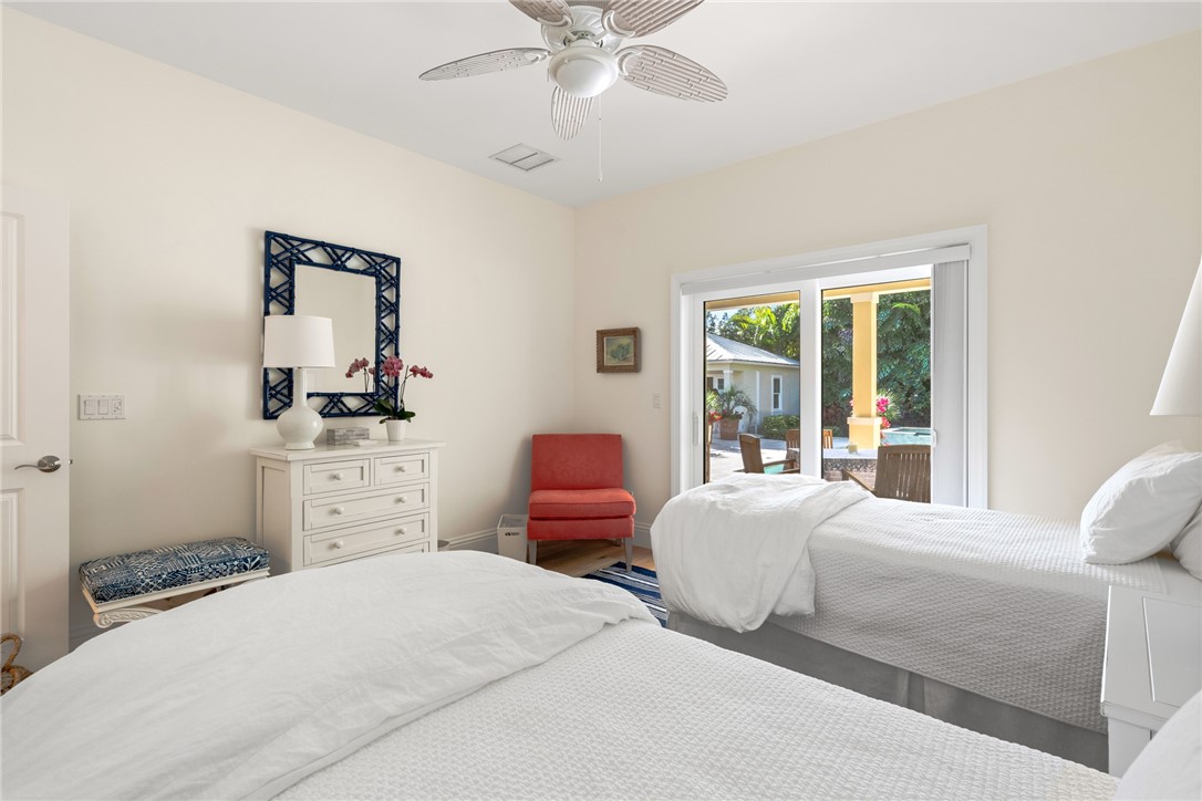 548 Conn Way Vero Beach, FL 32963 - Photo 28 of 34 a bedroom with a bed and wooden floor