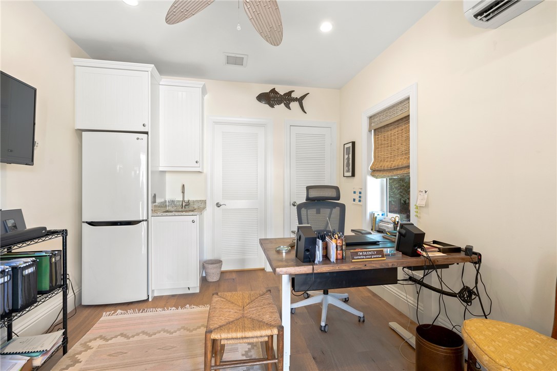 548 Conn Way Vero Beach, FL 32963 - Photo 30 of 34 a living room with furniture a refrigerator and a table