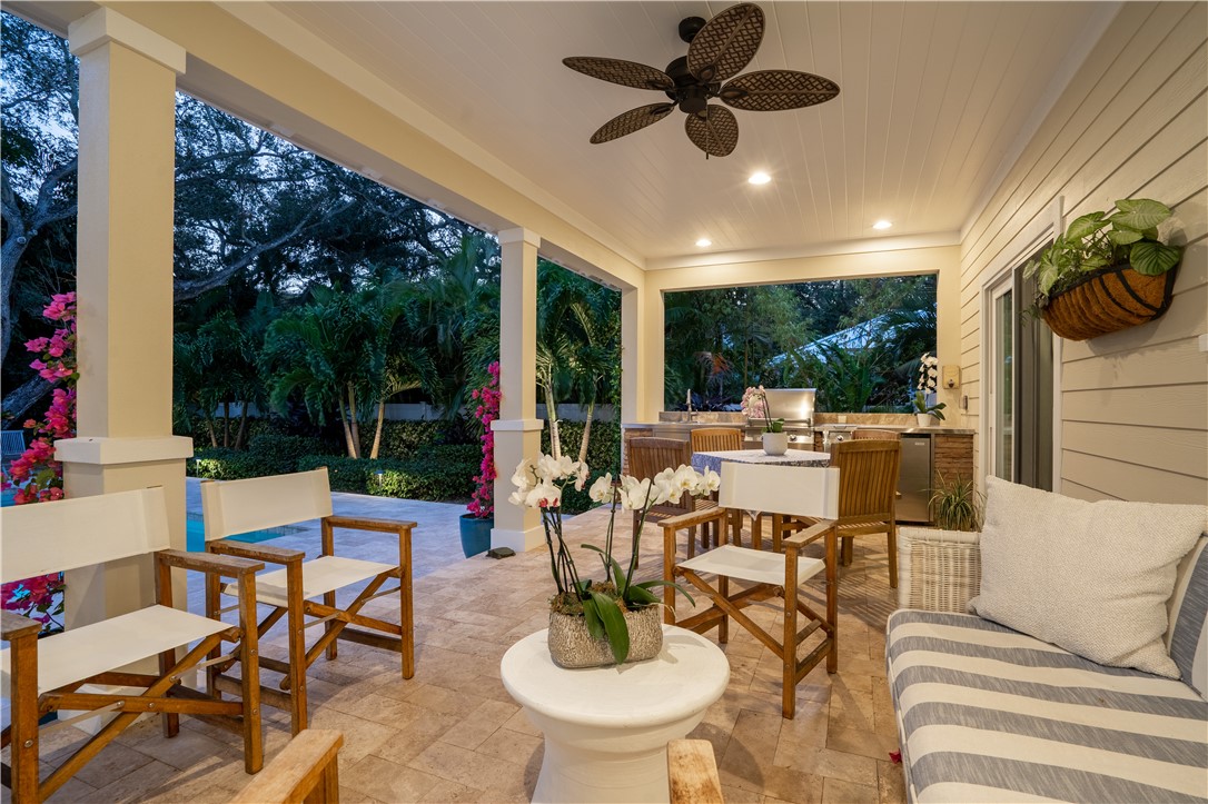 548 Conn Way Vero Beach, FL 32963 - Photo 7 of 34 a living room with patio furniture and a floor to ceiling window