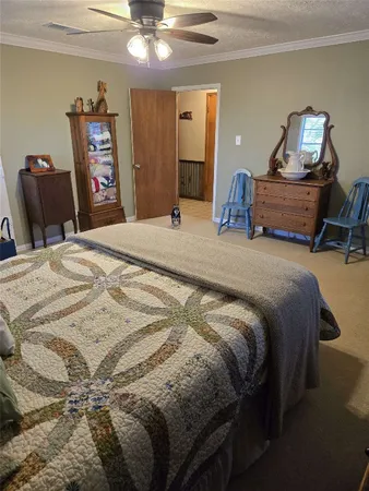 a bedroom with a bed and dresser