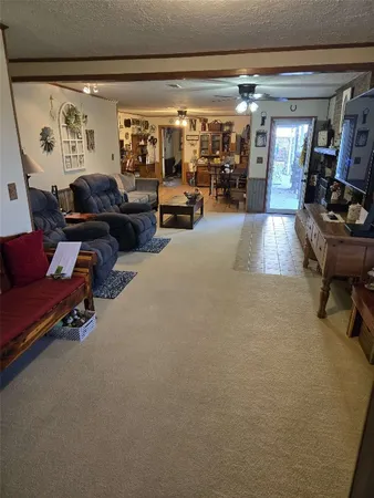 a living room with furniture and a gym machine