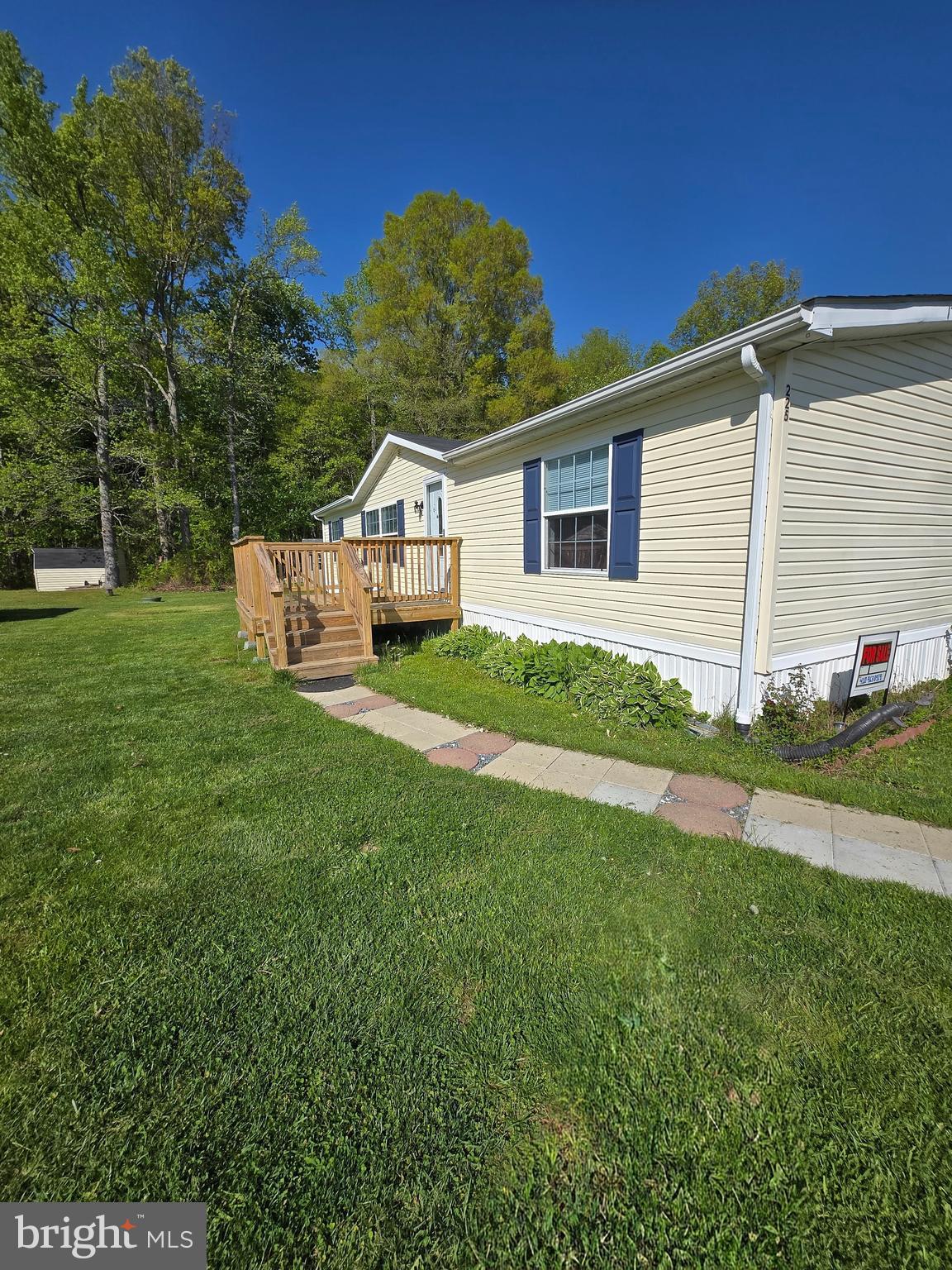 a view of a house with a big yard and potted plants