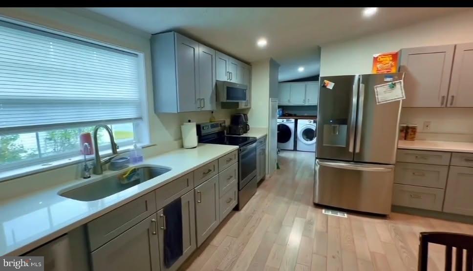 a kitchen with stainless steel appliances granite countertop a sink a stove and a refrigerator