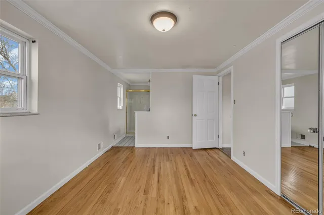 a view of room with wooden floor and fan
