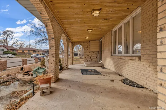 a view of a patio with table and chairs and potted plants