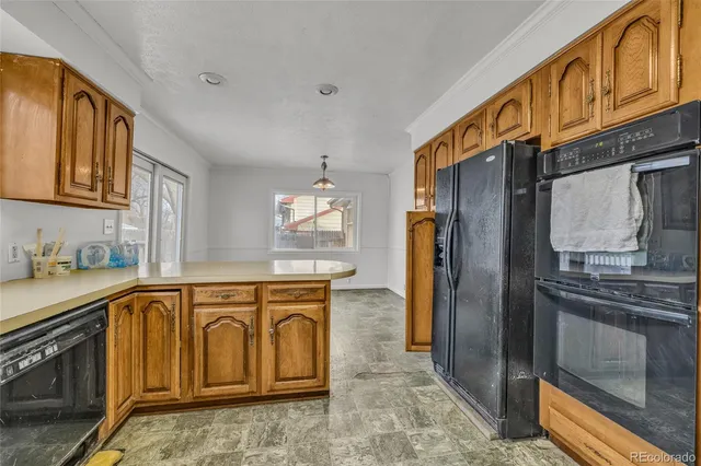 a kitchen with stainless steel appliances granite countertop a refrigerator a stove and a sink