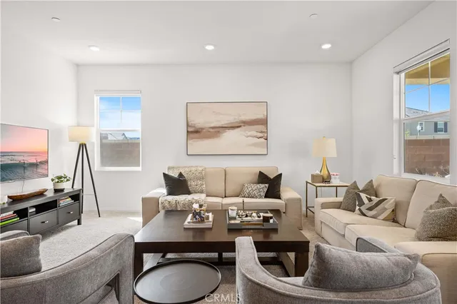 a living room with furniture a rug and a painting on the wall