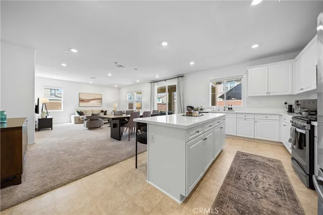 a kitchen with a sink a counter top space appliances and cabinets