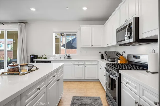 a kitchen with stainless steel appliances granite countertop a sink stove and cabinets