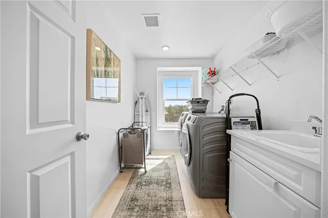 a room with two washing machine and sink