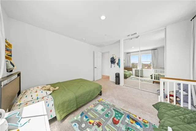 a bedroom with two beds and a couch