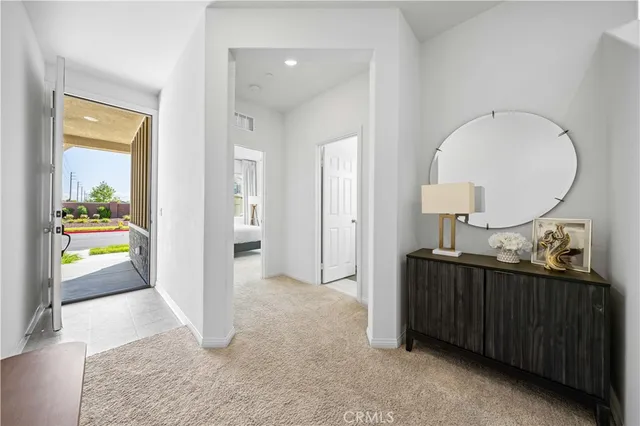 a view of a hallway view with two mirror and a lamp