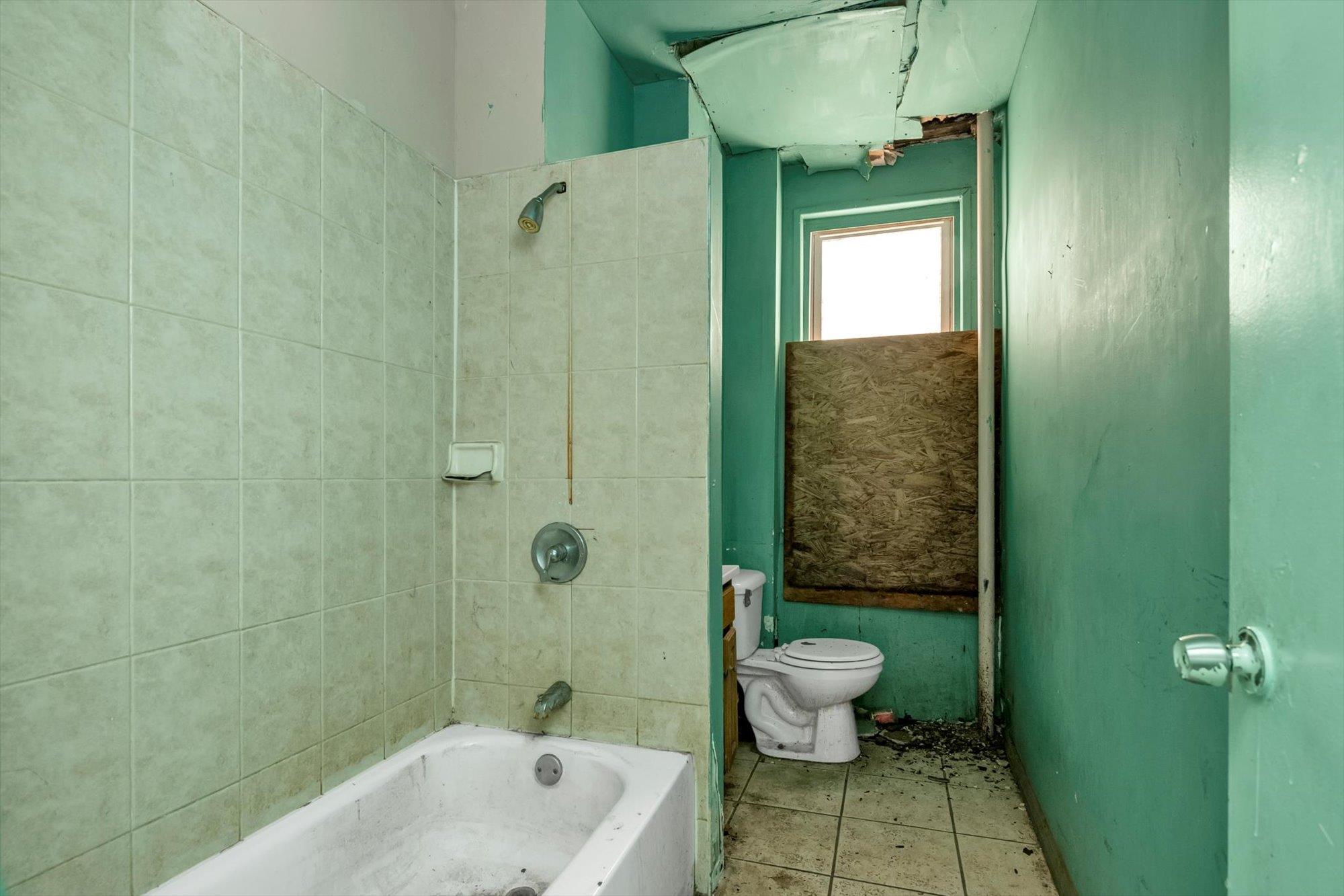 1129 East Tremont Avenue Bronx, NY 10460 - Photo 12 of 14 a bathroom with a sink a toilet and shower