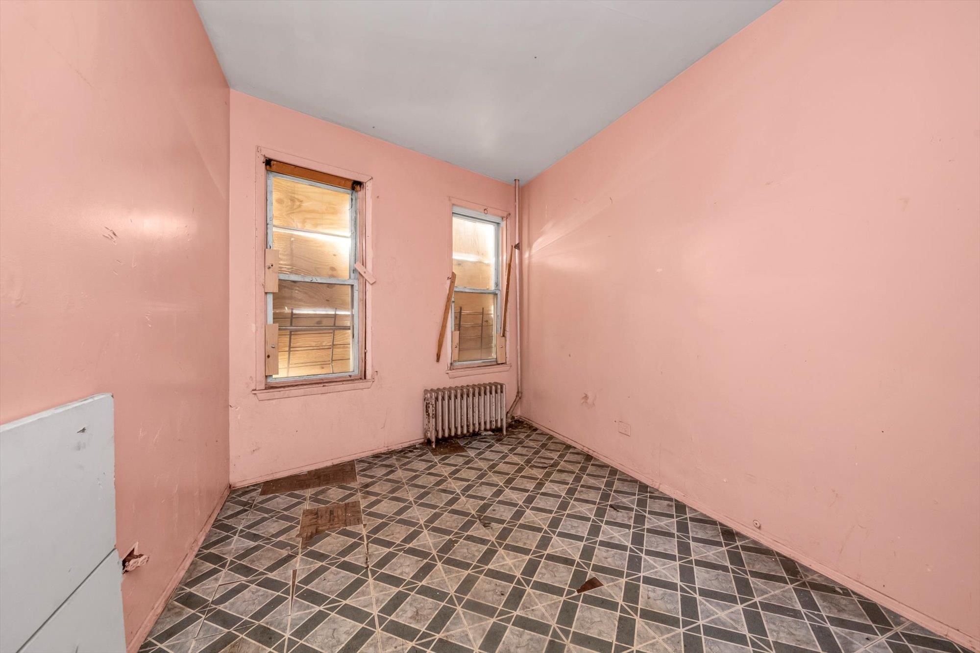 1129 East Tremont Avenue Bronx, NY 10460 - Photo 13 of 14 a view of an empty room and window