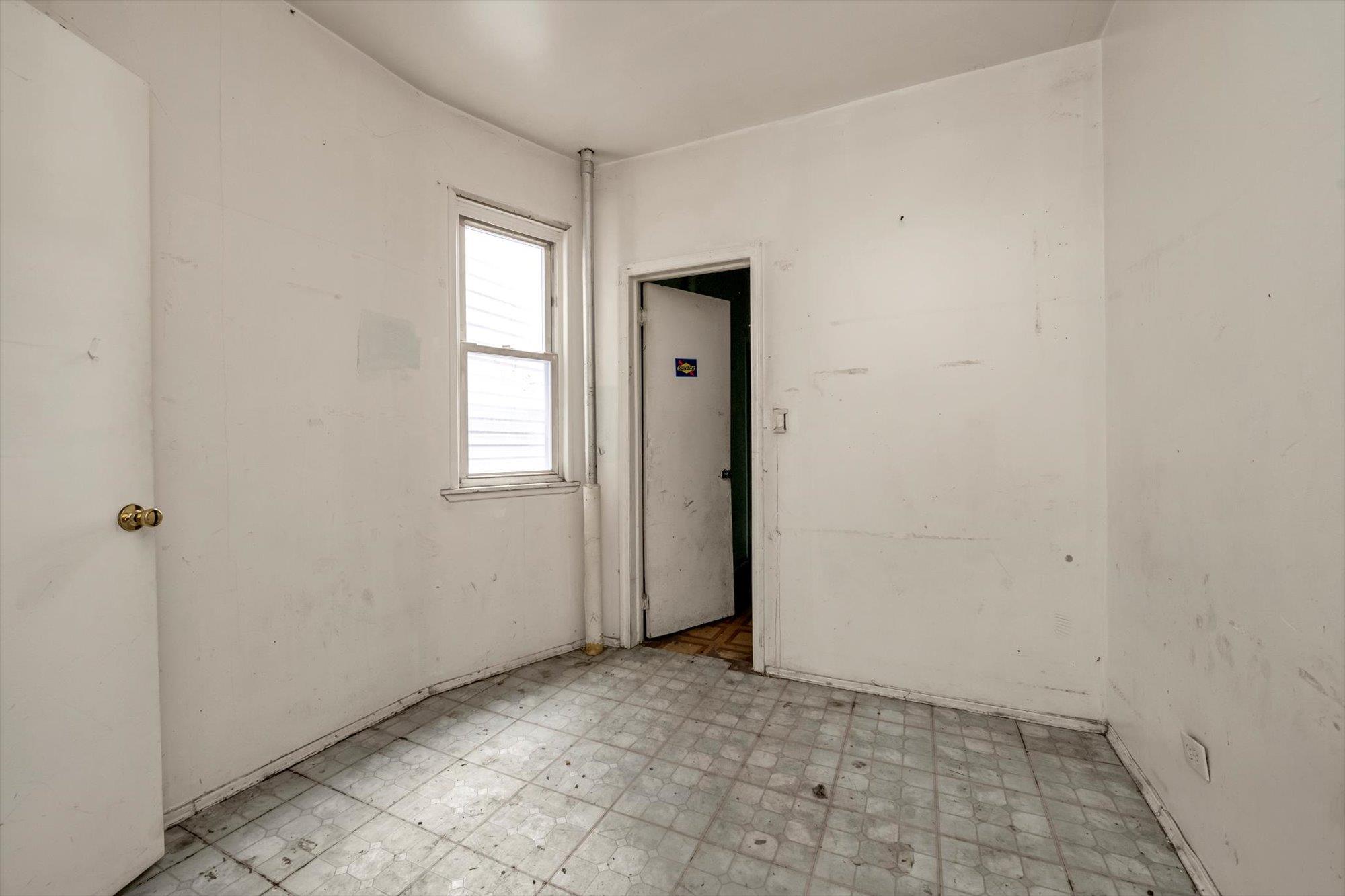 1129 East Tremont Avenue Bronx, NY 10460 - Photo 14 of 14 a view of an empty room with closet and a window