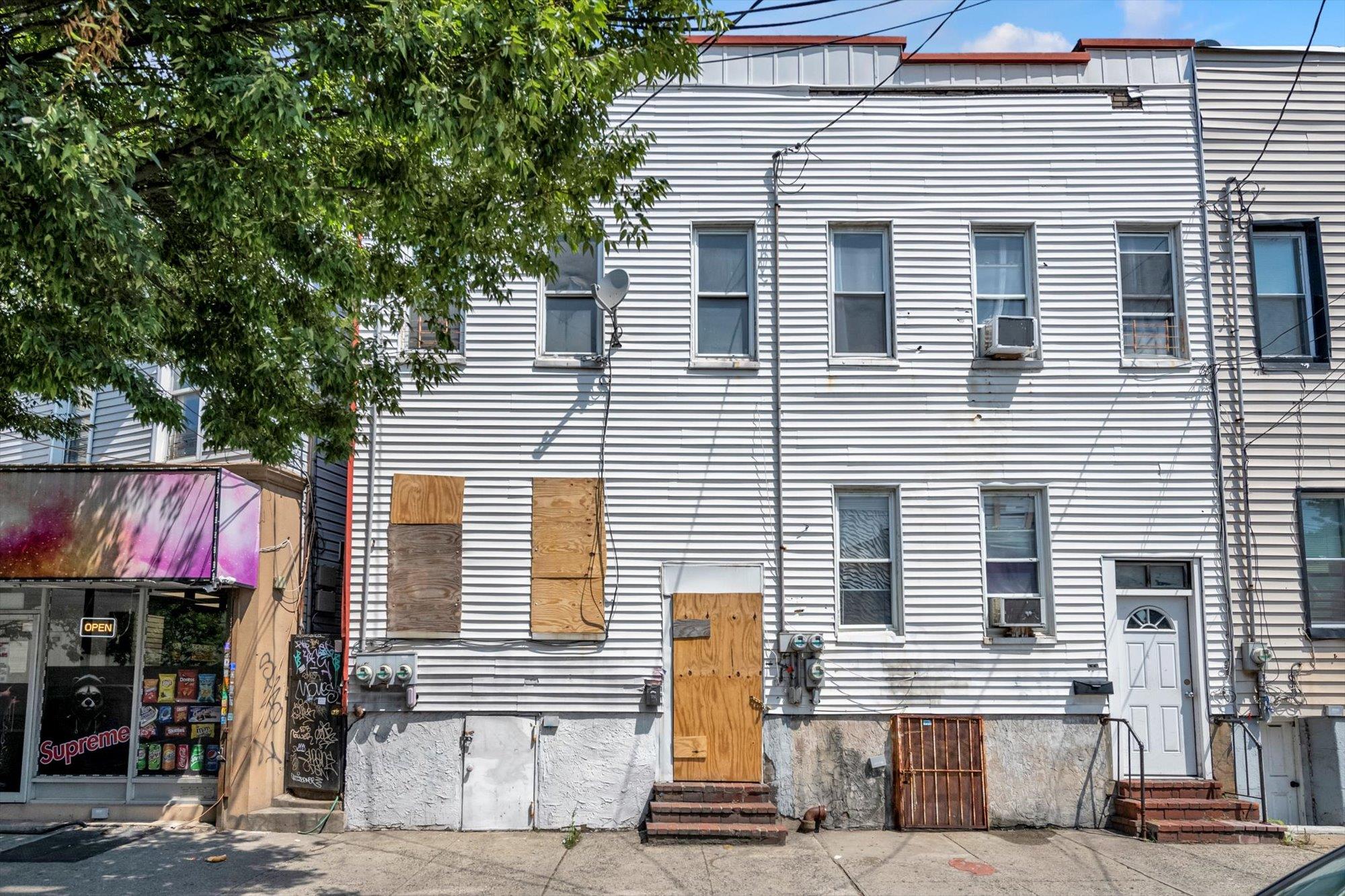 1129 East Tremont Avenue Bronx, NY 10460 - Photo 3 of 14 a front view of a house with a garage