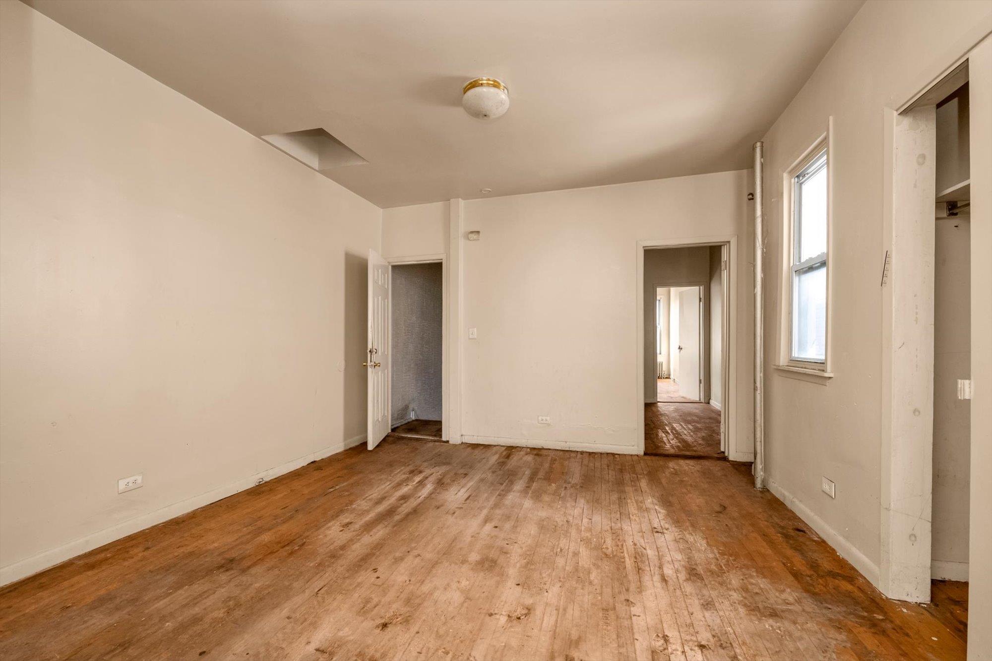 1129 East Tremont Avenue Bronx, NY 10460 - Photo 10 of 14 a view of empty room with wooden floor and fan
