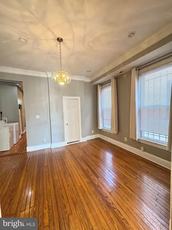 a view of a room with wooden floor and windows