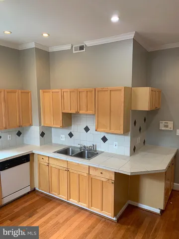a kitchen with a stove a sink and a window