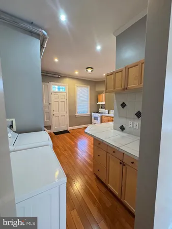 a large kitchen with stainless steel appliances granite countertop a stove and a sink