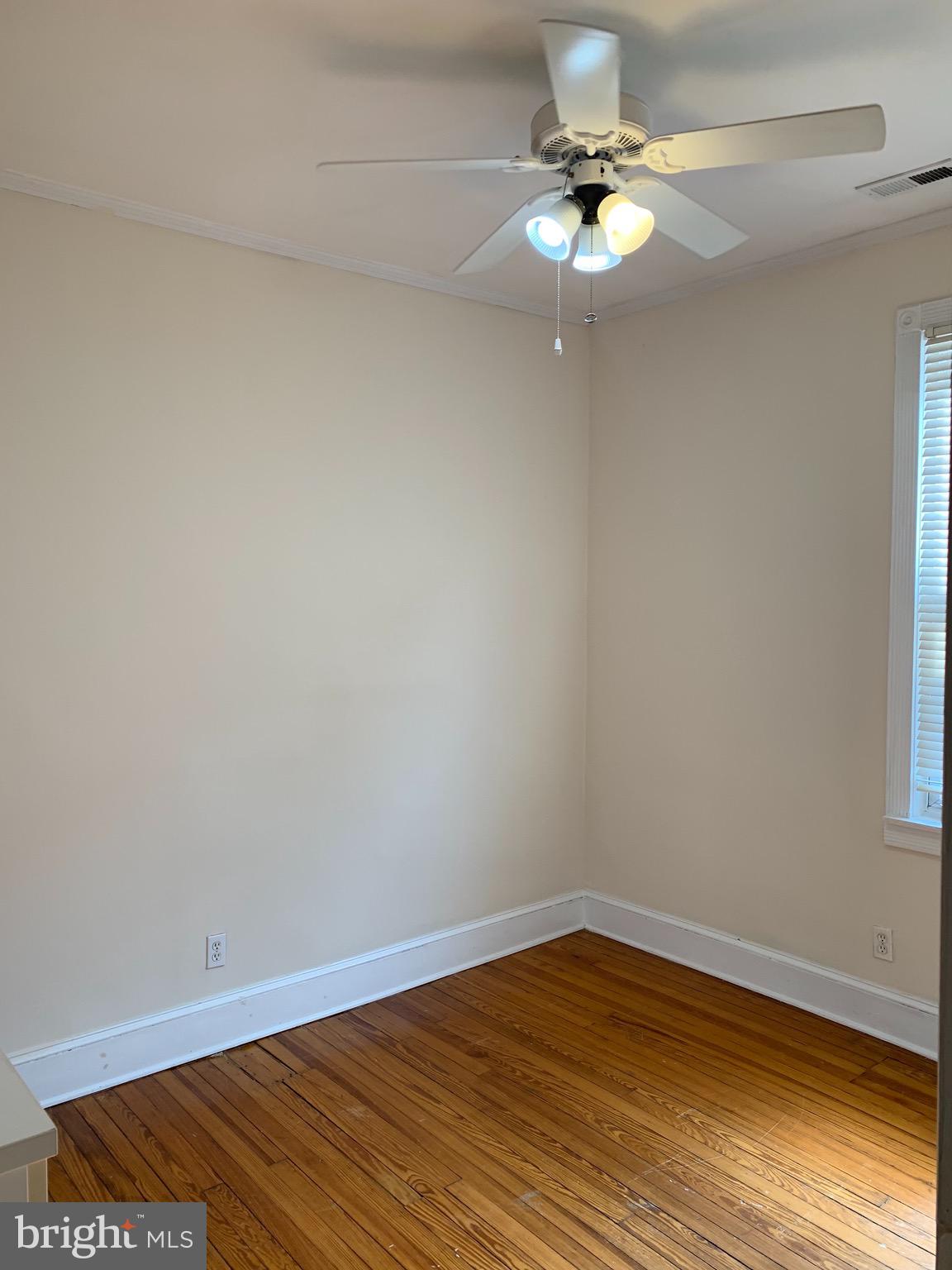15 Seaton Place Northwest, Unit 1 Washington, DC 20001 - Photo 28 of 34 a view of a room with wooden floor and a ceiling fan