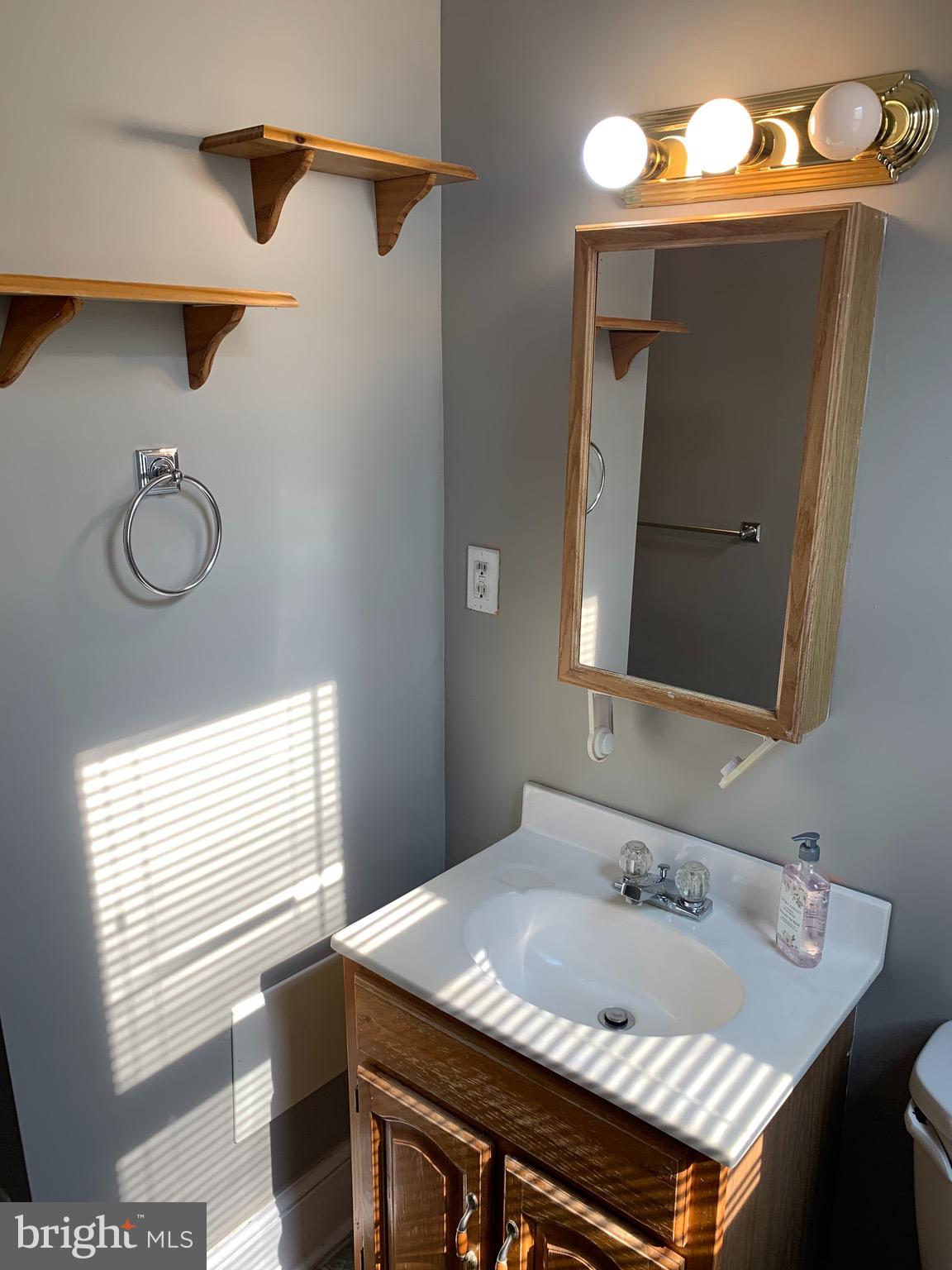 15 Seaton Place Northwest, Unit 1 Washington, DC 20001 - Photo 31 of 34 a bathroom with a granite countertop sink and a mirror