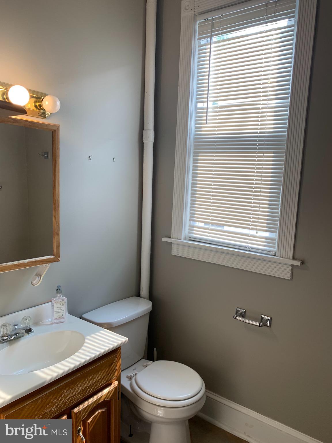 15 Seaton Place Northwest, Unit 1 Washington, DC 20001 - Photo 32 of 34 a white toilet sitting next to a bathroom sink