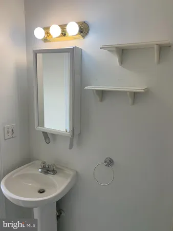 a bathroom with a tub a sink and glass door