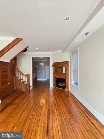 wooden floor fireplace and windows in a room