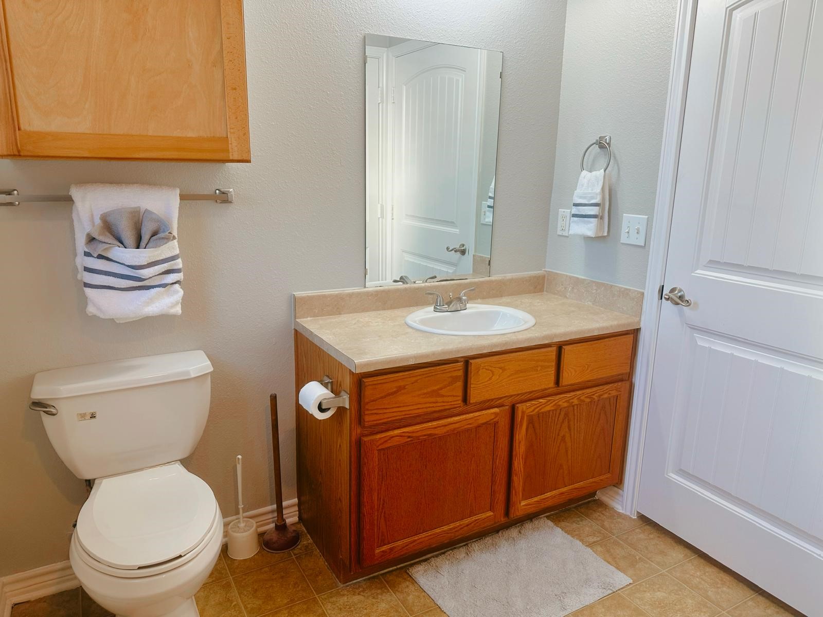 4480 Detroit Street Beaumont, TX 77703 - Photo 17 of 24 a bathroom with a granite countertop toilet sink and mirror