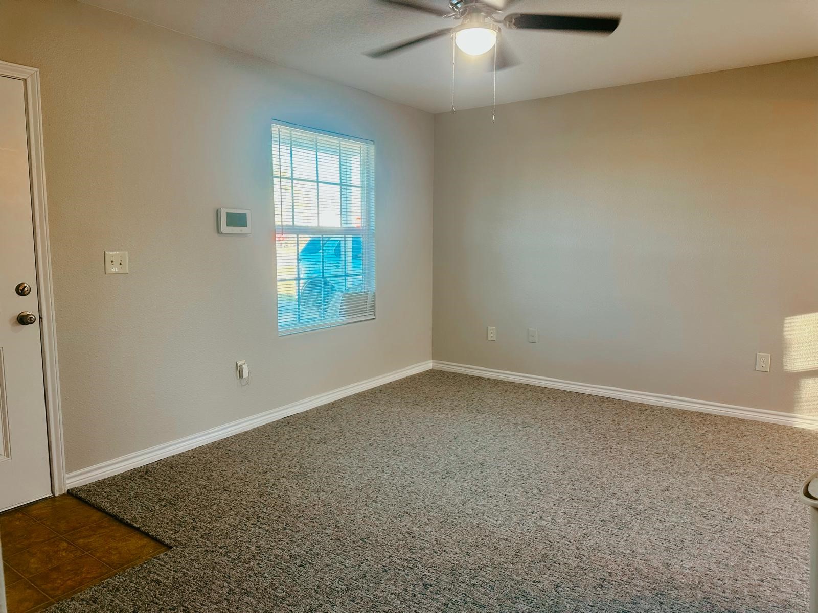 4480 Detroit Street Beaumont, TX 77703 - Photo 7 of 24 an empty room with windows and chandelier fan