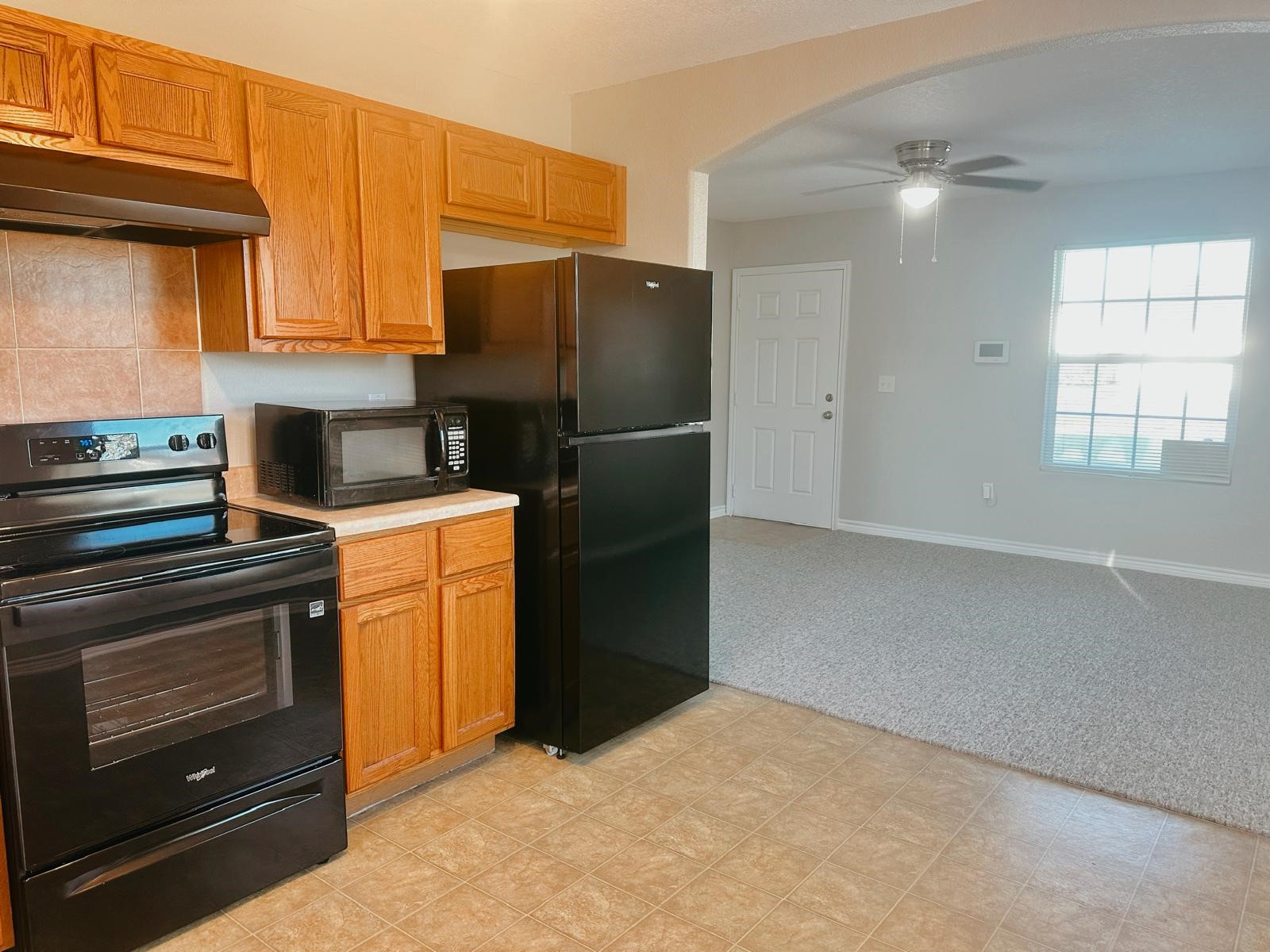 4480 Detroit Street Beaumont, TX 77703 - Photo 9 of 24 a kitchen with a refrigerator and cabinets