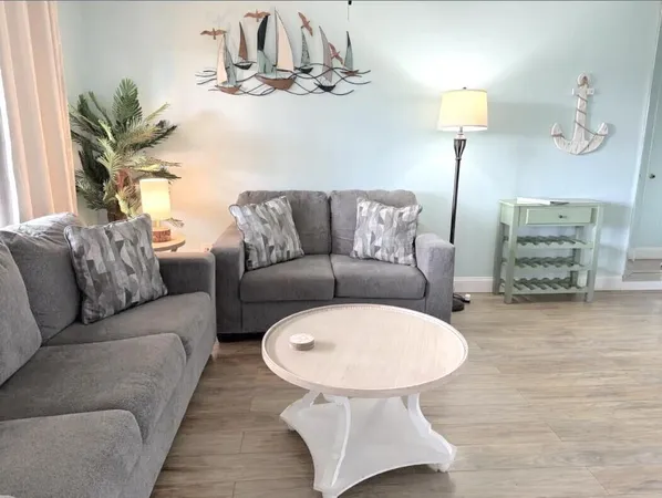 a living room with furniture a lamp and a chandelier