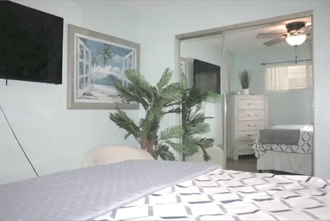 a bedroom with a bed and a flat screen tv