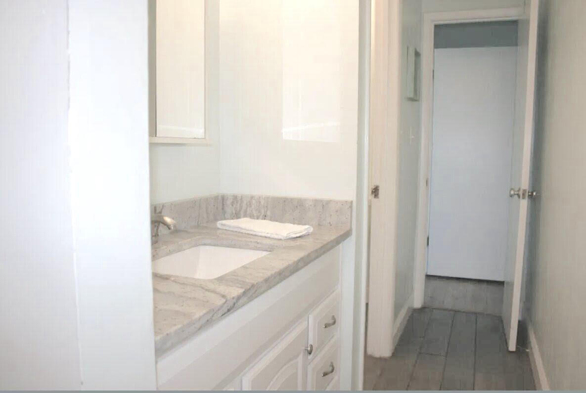 4000 Gulf Terrace Drive, Unit 2008 Destin, FL 32541 - Photo 14 of 35 a bathroom with a granite countertop sink and a mirror
