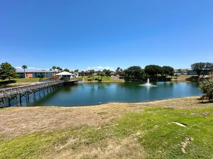 a view of a lake with boats and trees in the background