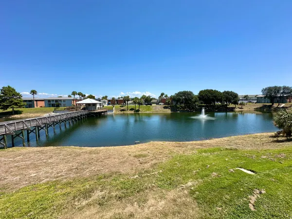 a view of a lake with boats and trees in the background